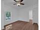 Bright bedroom with wood-look floors and ceiling fan at 5361 N Main St, Acworth, GA 30101