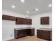 Modern kitchen with dark brown cabinets and granite countertops at 5361 N Main St, Acworth, GA 30101