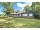 Brick ranch house with a white frame and large yard at 1736 Pleasant Grove Rd, Temple, GA 30179