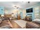 Living room with hardwood floors, two sofas, and a large TV at 1736 Pleasant Grove Rd, Temple, GA 30179