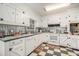 White kitchen with a farmhouse sink and metal backsplash at 1736 Pleasant Grove Rd, Temple, GA 30179