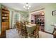 Bright dining room features a large table, wooden chairs, and built-in hutch at 1736 Pleasant Grove Rd, Temple, GA 30179