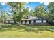 Ranch home with a large front yard and mature trees at 1736 Pleasant Grove Rd, Temple, GA 30179