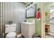 Small bathroom with a gray vanity and corrugated metal accent wall at 1736 Pleasant Grove Rd, Temple, GA 30179