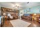 Living area with a brick fireplace and brown leather furniture at 1736 Pleasant Grove Rd, Temple, GA 30179