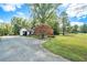 House with a long driveway and a colorful tree in the front yard at 1736 Pleasant Grove Rd, Temple, GA 30179