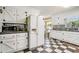 Spacious kitchen, white cabinets, checkerboard floor, and stainless steel appliances at 1736 Pleasant Grove Rd, Temple, GA 30179