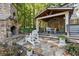 Stone patio with fireplace and comfortable seating at 315 Brandenburgh Cir, Roswell, GA 30075