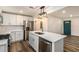 Open concept kitchen with white shaker cabinets, island, and stainless steel appliances at 408 Belgarde Place Se, Atlanta, GA 30354