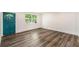 Bright living room featuring wood-look vinyl flooring and a teal door at 408 Belgarde Place Se, Atlanta, GA 30354