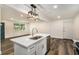 Modern kitchen island with white cabinets and a farmhouse sink at 408 Belgarde Place Se, Atlanta, GA 30354