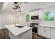 Modern kitchen with white cabinets, stainless steel appliances, and a quartz island at 408 Belgarde Place Se, Atlanta, GA 30354