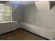 Unfinished basement room with a window and built-in bench at 237 Upshaw St, Atlanta, GA 30315