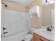 Updated bathroom with tub shower combo and wood vanity at 3127 Fields Dr, Lithonia, GA 30038