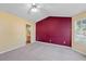 Bright bedroom with vaulted ceiling, neutral carpeting, and access to bathroom at 3127 Fields Dr, Lithonia, GA 30038