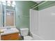Clean bathroom with tub shower combo, wood vanity, and updated fixtures at 3127 Fields Dr, Lithonia, GA 30038