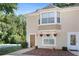 Tan two-story townhouse with a brown door and landscaping at 3127 Fields Dr, Lithonia, GA 30038