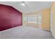 Large bedroom with tray ceiling, neutral carpeting, and an accent wall at 3127 Fields Dr, Lithonia, GA 30038