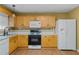 Bright kitchen features ample wood cabinets, tile backsplash, and modern appliances at 3127 Fields Dr, Lithonia, GA 30038