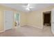 Well-lit bedroom with ceiling fan, access to bathroom and stairs to upper level at 3127 Fields Dr, Stonecrest, GA 30038