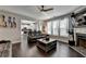 Open living room with kitchen view, hardwood floors, and recessed lighting at 1567 Maplecliff Way, Sugar Hill, GA 30518