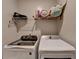 Convenient laundry room with washer, dryer, and overhead shelving at 1567 Maplecliff Way, Sugar Hill, GA 30518