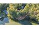 Aerial view of lakefront home nestled among trees at 7149 Burnside Ct, Villa Rica, GA 30180