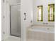 Elegant bathroom with soaking tub, shower, and stained glass windows at 7149 Burnside Ct, Villa Rica, GA 30180