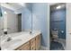 Light blue bathroom boasts double sinks and a toilet at 7149 Burnside Ct, Villa Rica, GA 30180