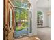 Open entryway with hardwood floors, arched windows, and a view of the backyard at 7149 Burnside Ct, Villa Rica, GA 30180