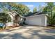 Home exterior with attached garage and lake view at 7149 Burnside Ct, Villa Rica, GA 30180