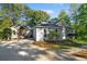 Gray house with stone accents, driveway, and landscaping; located in a wooded area at 7149 Burnside Ct, Villa Rica, GA 30180