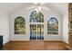 Gathering room with vaulted ceiling, hardwood floors, fireplace, and large windows at 7149 Burnside Ct, Villa Rica, GA 30180