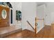 Hardwood floor hallway with staircase and view into the living room at 7149 Burnside Ct, Villa Rica, GA 30180