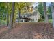 Two-story house with deck overlooking a yard with fallen leaves at 7149 Burnside Ct, Villa Rica, GA 30180