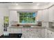 Kitchen with granite countertops and a large window overlooking the lake at 7149 Burnside Ct, Villa Rica, GA 30180