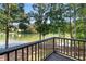 Deck overlooks peaceful lake with tree-lined shores at 7149 Burnside Ct, Villa Rica, GA 30180