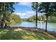 Scenic lakefront property with lush trees and tranquil waters at 7149 Burnside Ct, Villa Rica, GA 30180