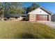 Stone and wood exterior, two-car garage, and nicely landscaped yard at 5934 S Deshon Ct, Lithonia, GA 30058