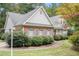 Ranch-style house with brick facade and gray roof, surrounded by landscaping at 2797 Club Forest Dr, Conyers, GA 30013