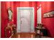 Bright red entryway with hardwood floors and decorative accents at 2797 Club Forest Dr, Conyers, GA 30013