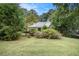 Ranch style home with a large front yard and mature trees at 2797 Club Forest Dr, Conyers, GA 30013