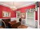 Charming dining room with hardwood floors, a table for four, and floral wallpaper at 2797 Club Forest Dr, Conyers, GA 30013