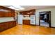 Kitchen boasts wood cabinets and hardwood floors at 4503 Rivercliff Sw Dr, Lilburn, GA 30047