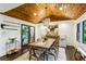 Dining room with wood ceiling, chandelier, and farmhouse-style table at 7350 Ono Rd, Palmetto, GA 30268