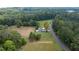 Aerial view of home on a spacious lot with adjacent fields at 7350 Ono Rd, Palmetto, GA 30268