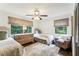 Charming bedroom with two twin beds, dresser, and dark hardwood floors at 7350 Ono Rd, Palmetto, GA 30268