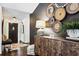 Bright entryway with decorative wall hanging, wooden console table, and cowhide rug at 7350 Ono Rd, Palmetto, GA 30268