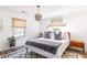 Bright bedroom with a king-size bed, new flooring, and a modern chandelier at 7350 Ono Rd, Palmetto, GA 30268