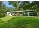 Ranch home with white brick exterior, landscaped lawn, and stone walkway at 7350 Ono Rd, Palmetto, GA 30268